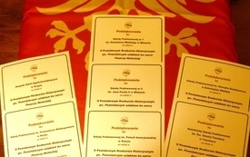 Na pierwszym planie podziękowania dla szk&oacute;ł za udział w konkursie; w tle czerwona flaga z białym orłem